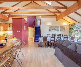 A capacious kitchen-living area with comfy seating for all - ideal for entertaining large groups of friends and family