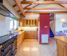 A smart, well-fitted and capacious kitchen area replete with kitchen appliances for all events - ideal for preparing food for entertaining large groups of friends and family.