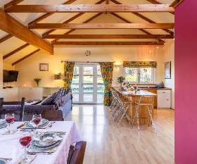 A capacious kitchen-living area with comfy seating for all - ideal for entertaining large groups of friends and family