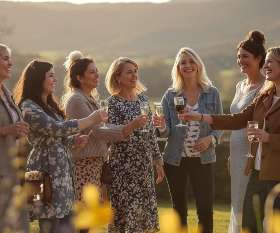 Group of friends celebrating a spring hen weekend 2026 in the private gardens