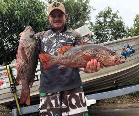 Holding The Fish He Caught - True Blue Fishing