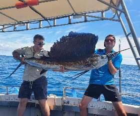 Holding The Fish He Caught- True Blue Fishing